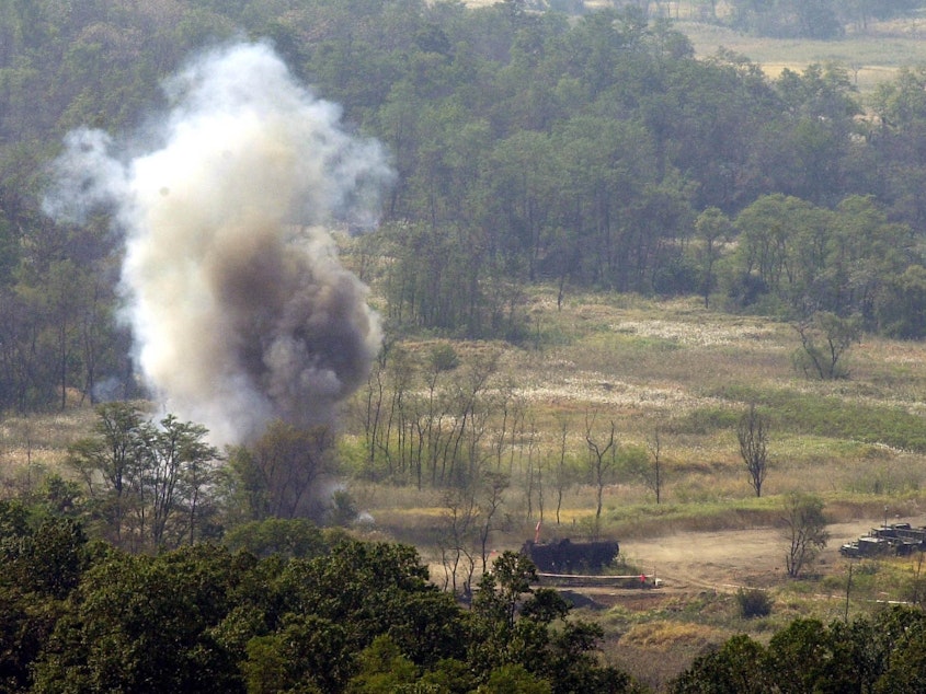 caption: Smoke rises after South Korean soldiers set a blast to remove land mines in the Demilitarized Zone in 2002. The Korean Peninsula had been the last region the U.S. military was allowed to use the weapon — until Friday, when the Trump administration lifted the Obama-era restriction.