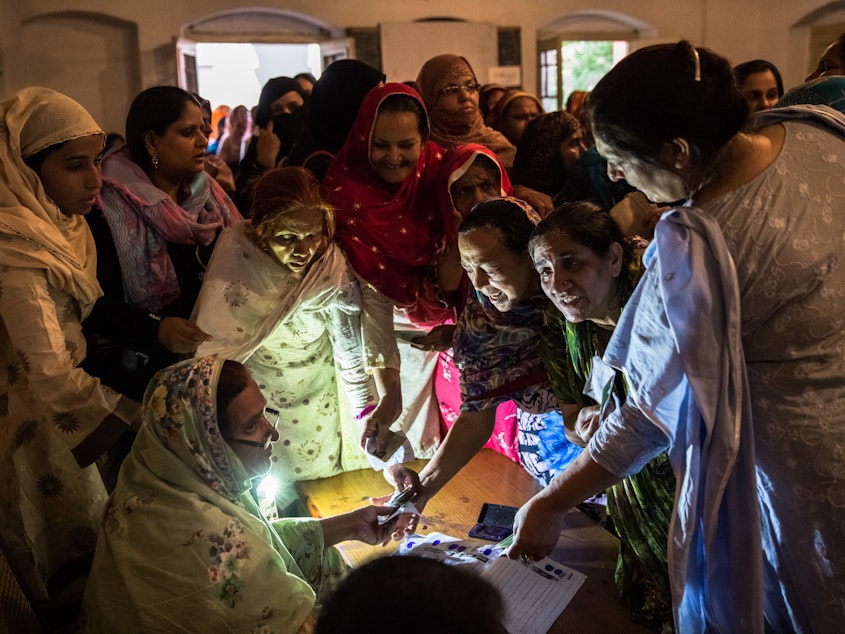 caption: Pakistani women jostle to receive their ballot papers prior to casting their ballot at a polling station on May 11, 2013 in Lahore. A study in <em>The Lancet</em> provides evidence that free and fair elections are associated with a lower burden of chronic diseases.