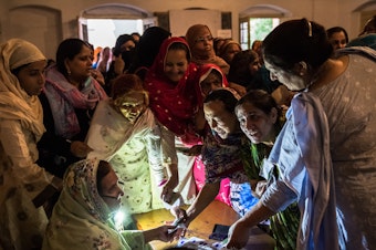 caption: Pakistani women jostle to receive their ballot papers prior to casting their ballot at a polling station on May 11, 2013 in Lahore. A study in <em>The Lancet</em> provides evidence that free and fair elections are associated with a lower burden of chronic diseases.
