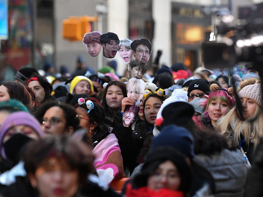 caption: Fans await the K-pop boy band BTS visit to the <em>Today</em> show at Rockefeller Plaza in New York City last year.