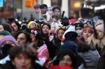 caption: Fans await the K-pop boy band BTS visit to the <em>Today</em> show at Rockefeller Plaza in New York City last year.
