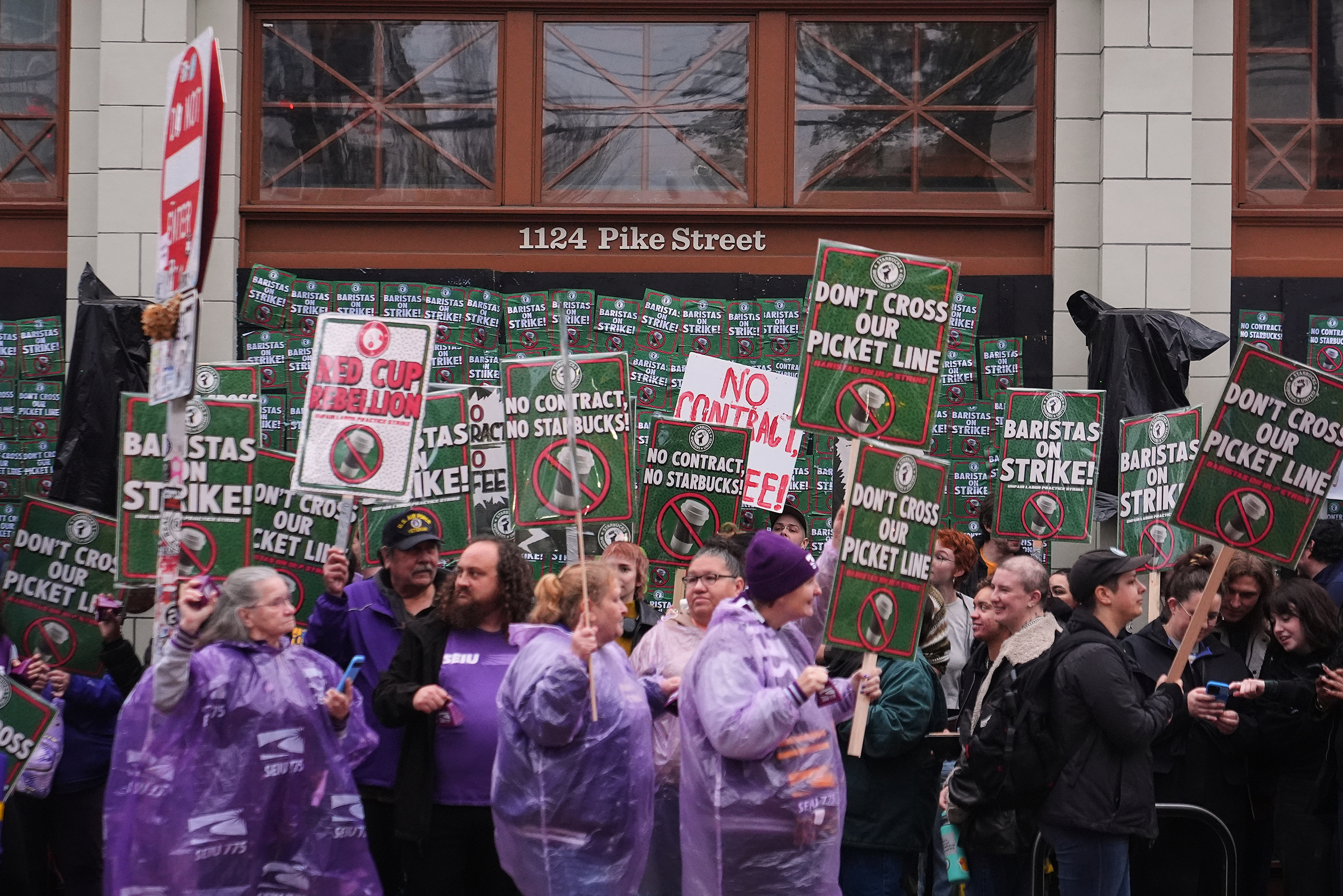 caption: Starbucks employees and supporters strike in front of the former Starbucks Reserve Roastery that closed earlier in the year, Thursday, Nov. 13, 2025, in Seattle. 