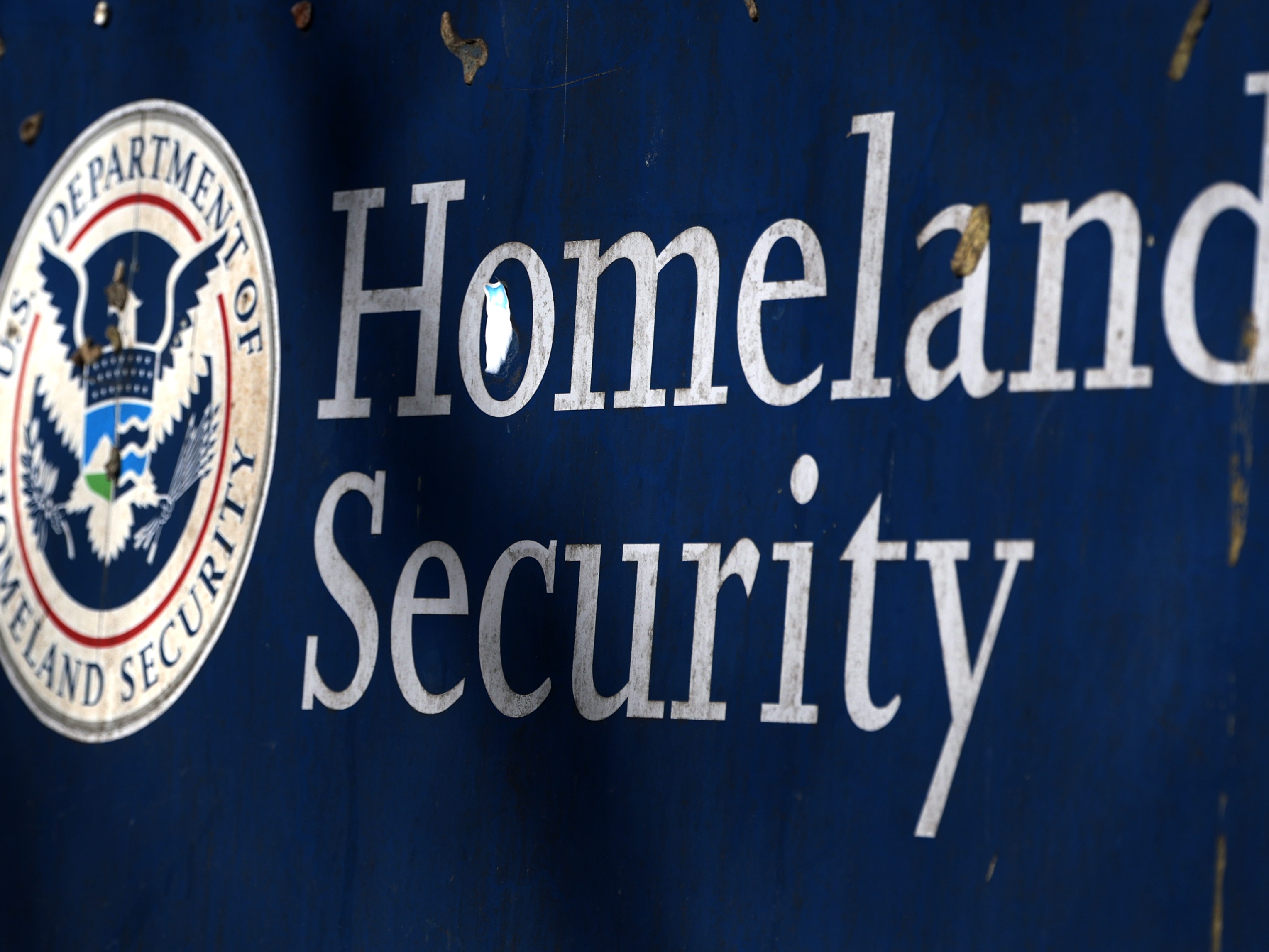 caption: The Department of Homeland Security's sign is seen outside its headquarters on February 13, 2026 in Washington, D.C.