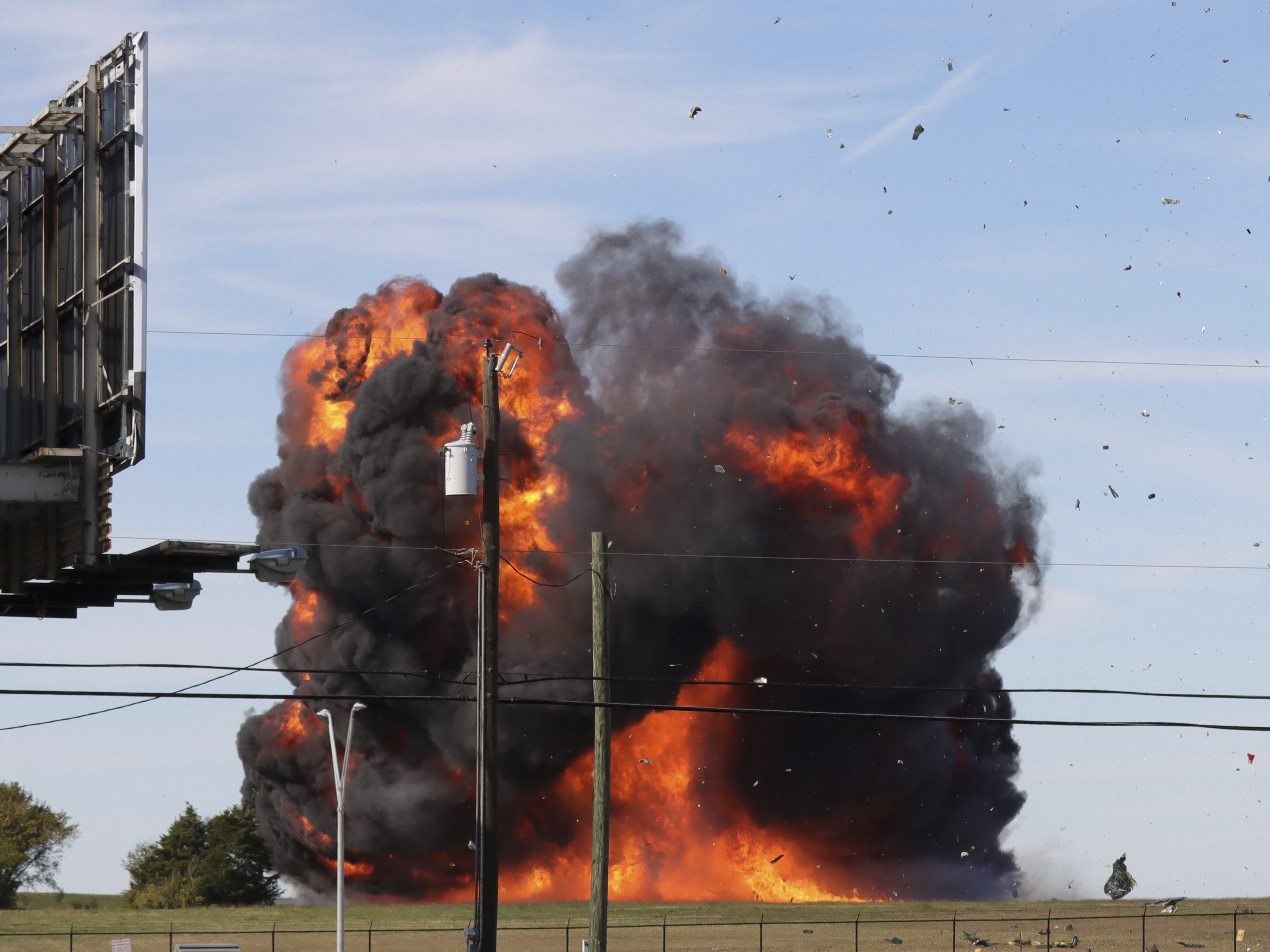 caption: A historic military plane crashes after colliding with another plane during an airshow at Dallas Executive Airport in Dallas on Saturday.