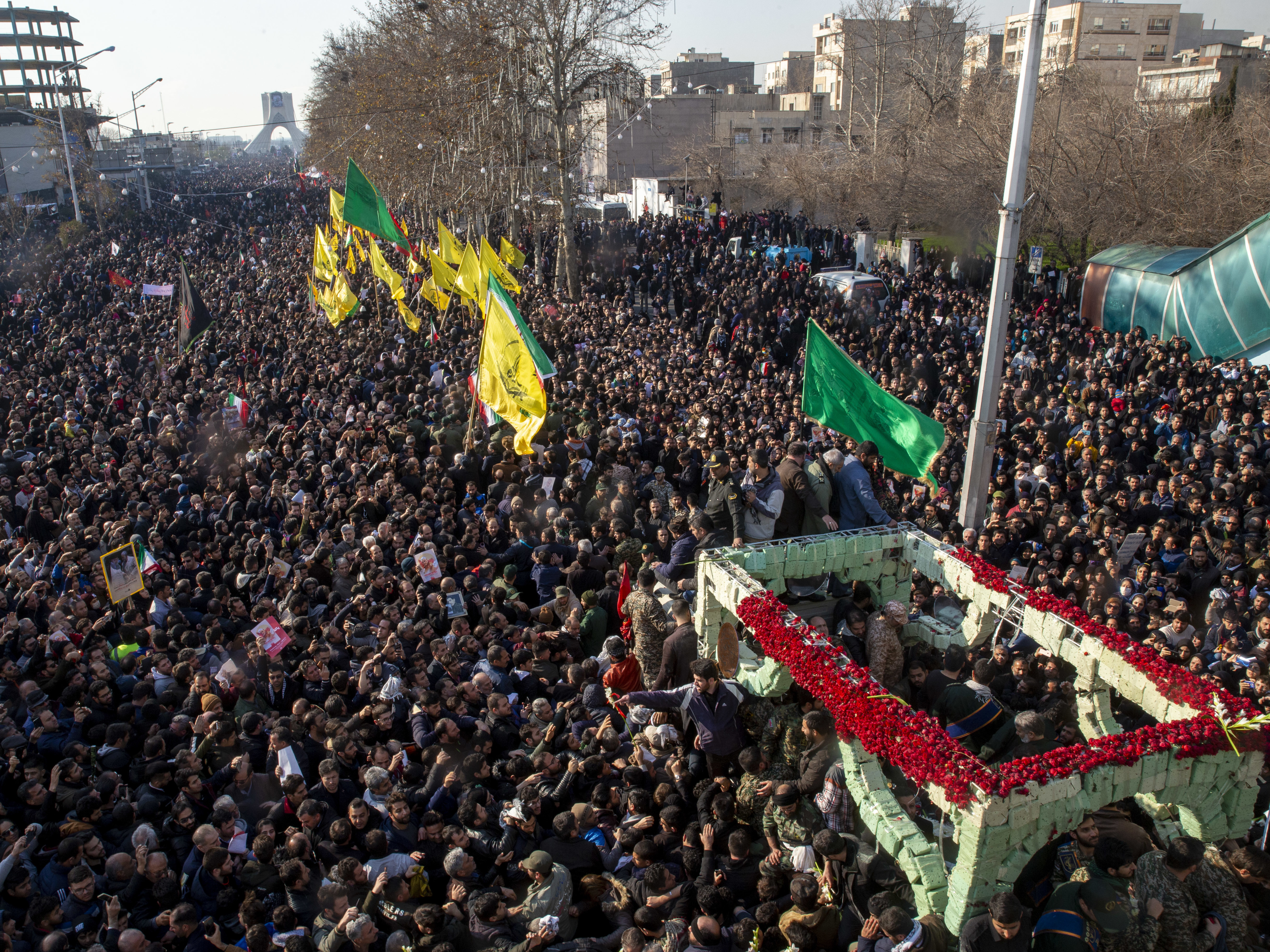 caption: During a funeral procession on Monday, mourners surround a truck carrying the coffins of Iranian Maj. Gen. Qassem Soleimani and others who were killed in Iraq by a U.S. drone strike.