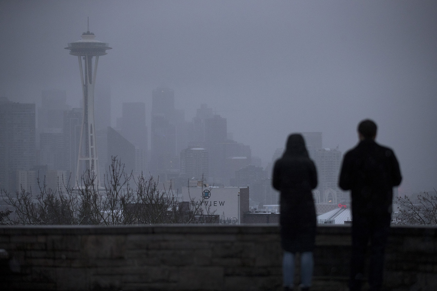 caption: Snow falls on downtown Seattle on Sunday, February 3, 2019, from Kerry Park.