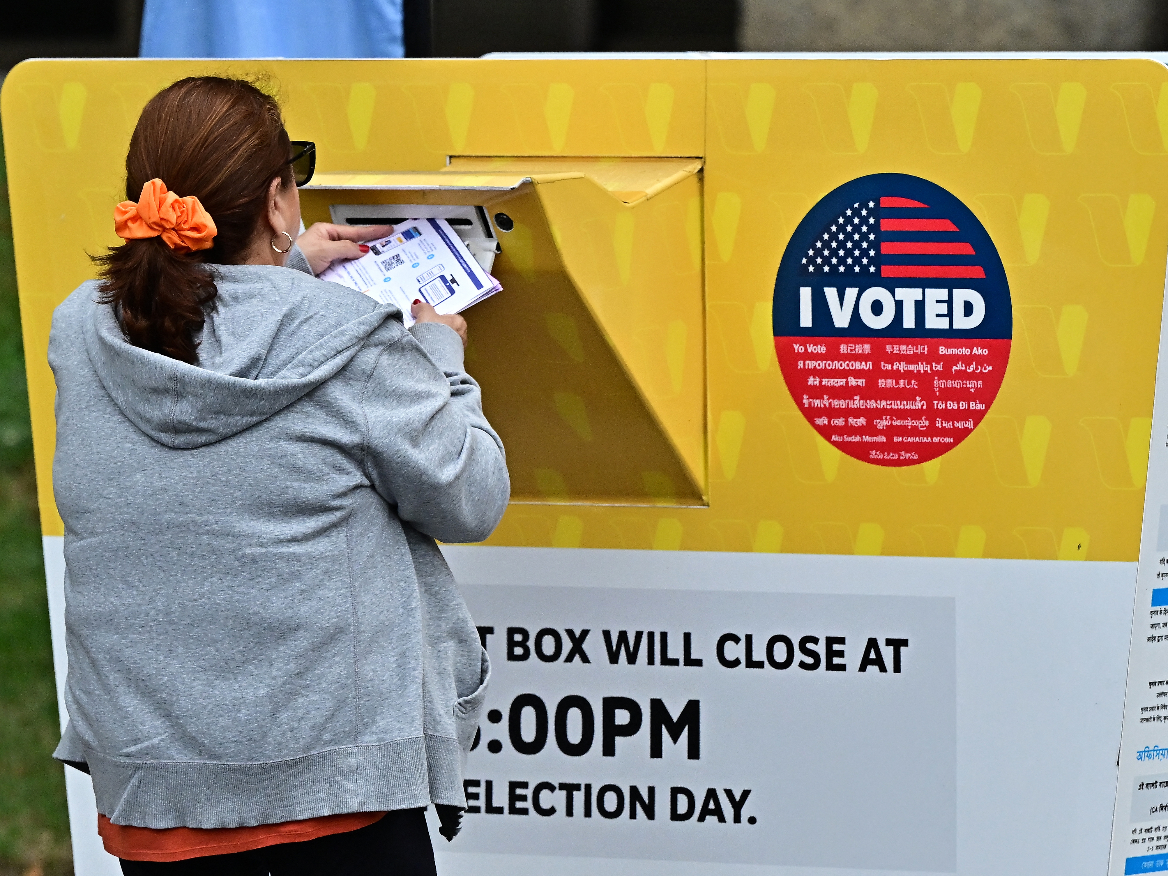 caption: A voter puts their ballot in a drop box in Norwalk, Calif., during early voting in Los Angeles County. People who vote in the 2024 general election can track their ballots as they move through the system.