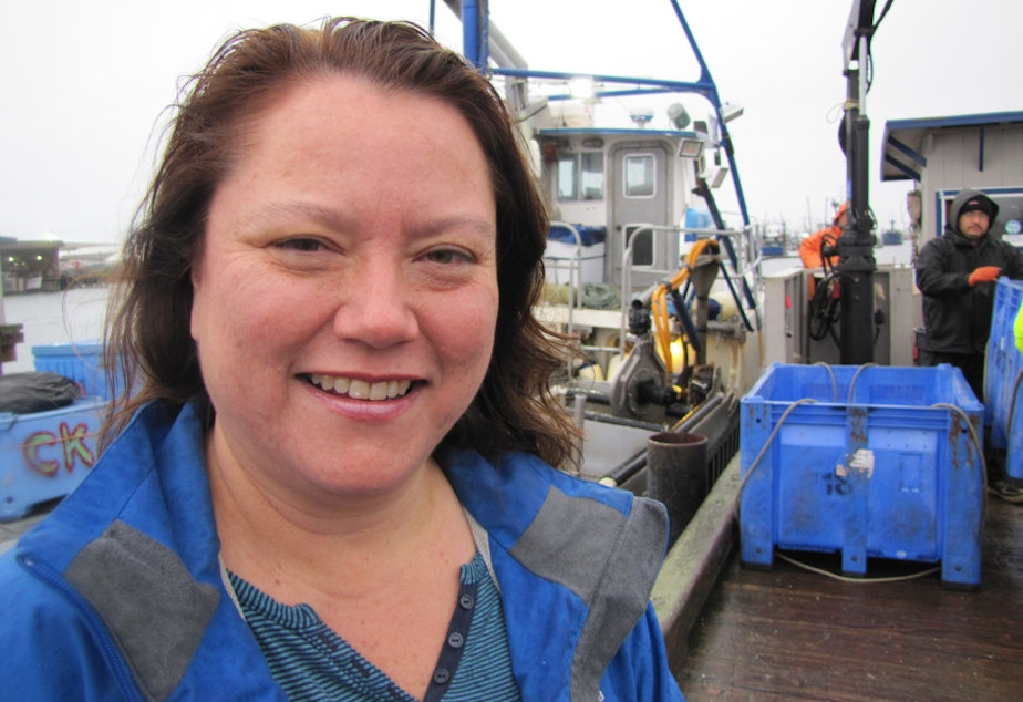 caption: Fawn Sharp, president of the Quinault Indian Nation, stands on the docks as tribal crabbers unload their catch. The tribe has vowed to fight the oil train-to-ship terminals proposed for Grays Harbor.