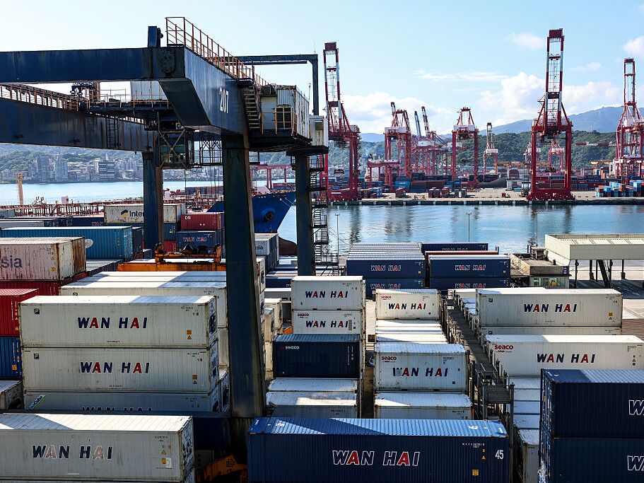 caption: Shipping containers are stacked at the port in Keelung, Taiwan, on Friday.