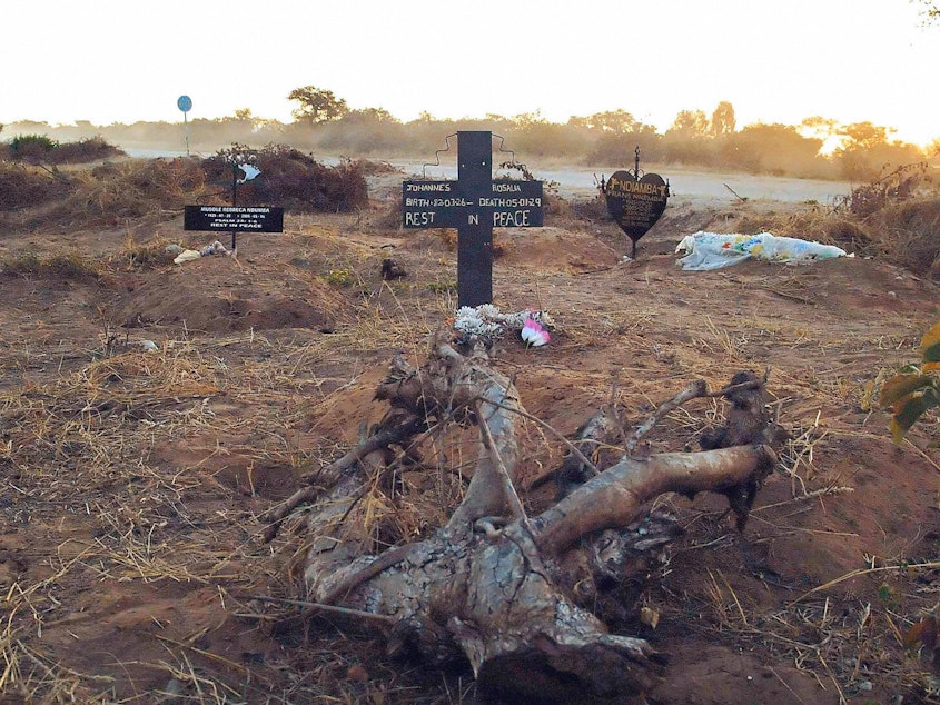 caption: An illegal roadside graveyard in northeastern Namibia. People in the townships surrounding Rundu, a town on the border to Angola, are too poor to afford a funeral plot at the municipal graveyard — and resorted to burying their dead next to a dusty gravel road just outside of the town.