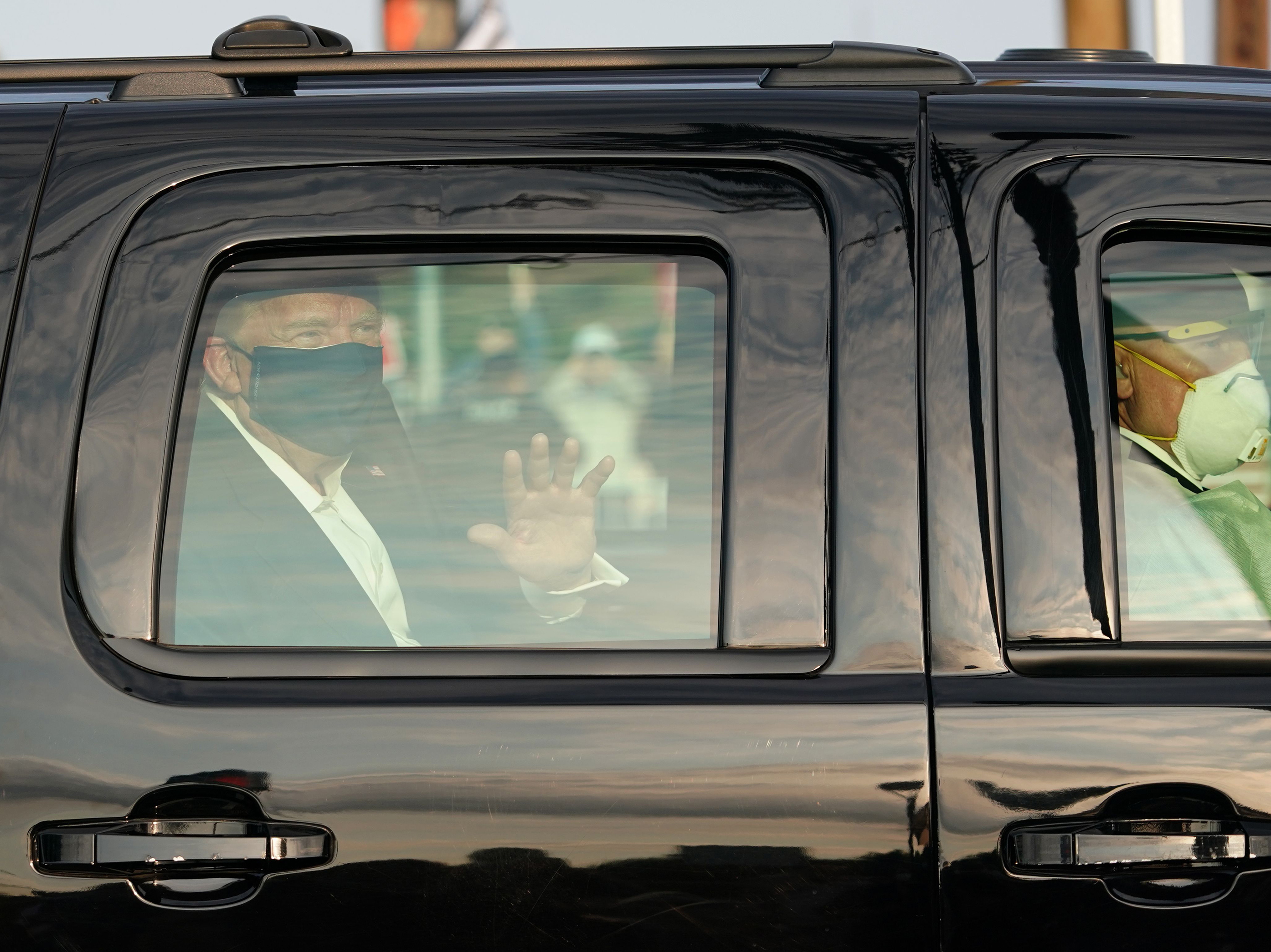 caption: Despite public health recommendations that people infected with the coronavirus isolate themselves to prevent further transmission, President Trump rode with Secret Service agents past his supporters outside Walter Reed National Military Medical Center on Sunday.