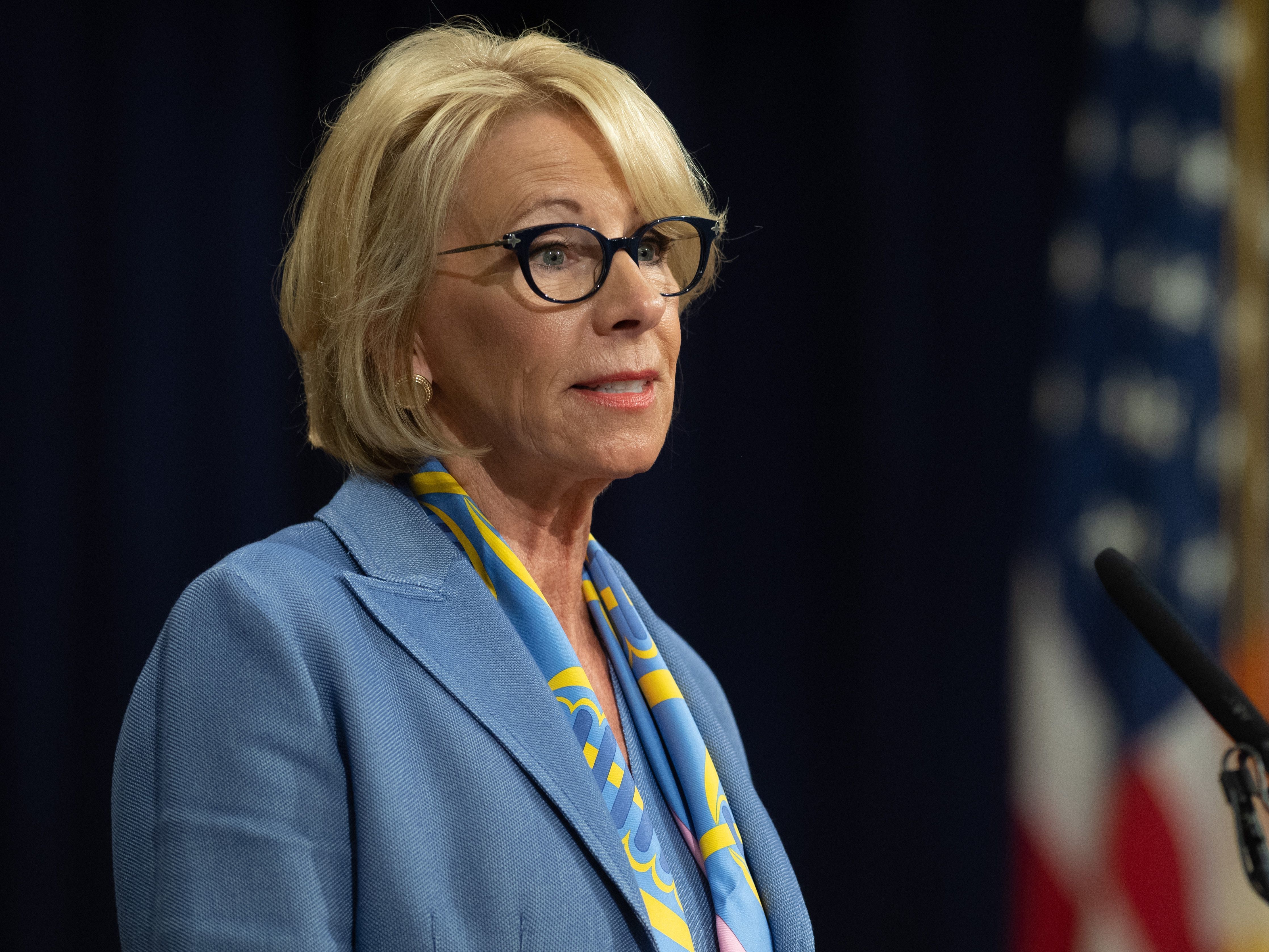 caption: Education Secretary Betsy DeVos speaks at the Department of Justice in July.