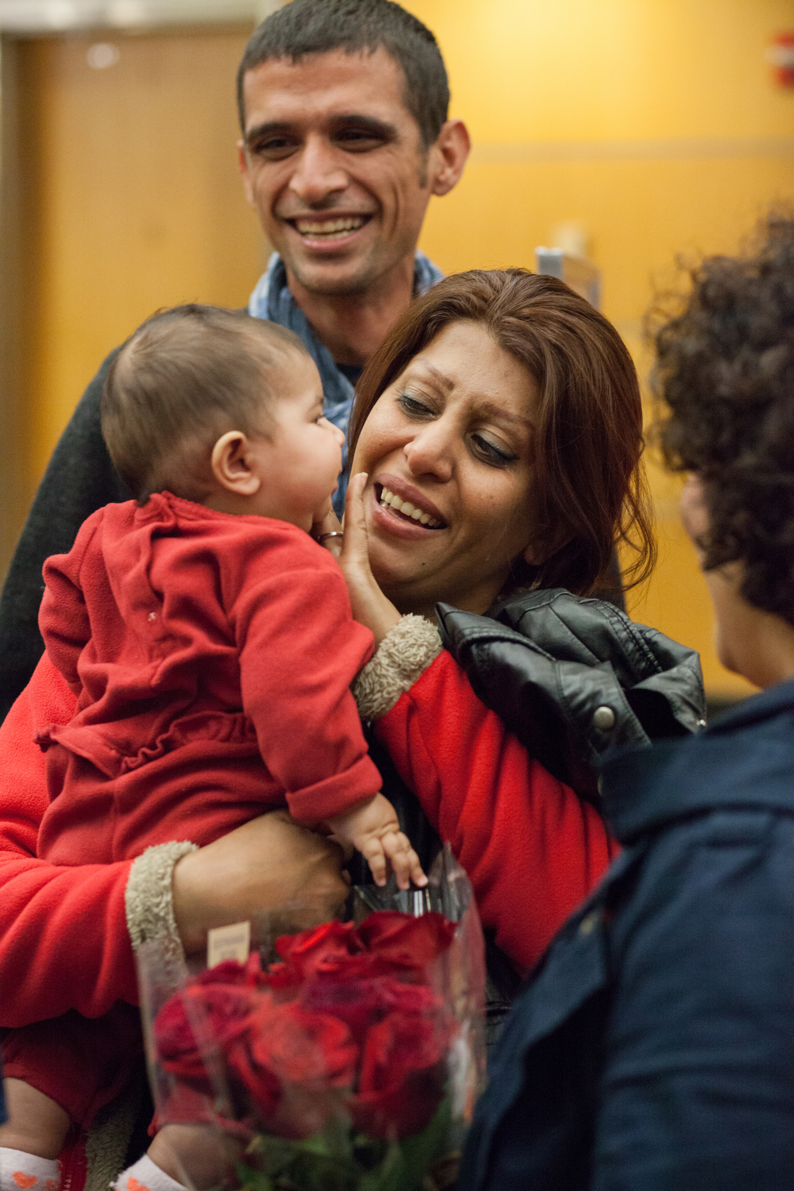 caption: A refugee family from Iran arrives at SeaTac Airport in 2015