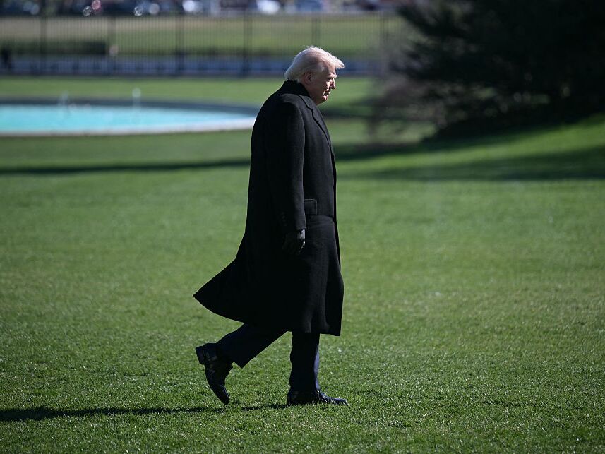 caption: President Trump walks to the Oval Office at the White House in Washington, D.C., as he returns from Dover Air Force Base in Delaware after attending a dignified transfer solemn event on Wednesday.