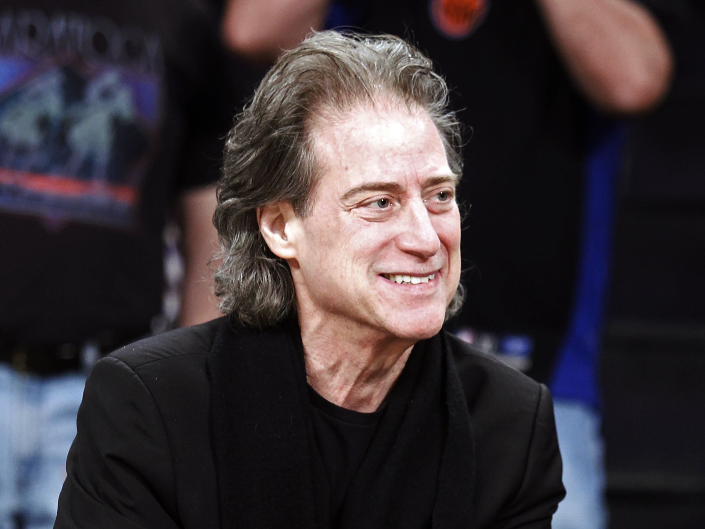 caption: Comedian Richard Lewis attends an NBA basketball game in Los Angeles on Dec. 25, 2012. Lewis, an acclaimed comedian known for exploring his neuroses in frantic, stream-of-consciousness diatribes, has died at age 76.
