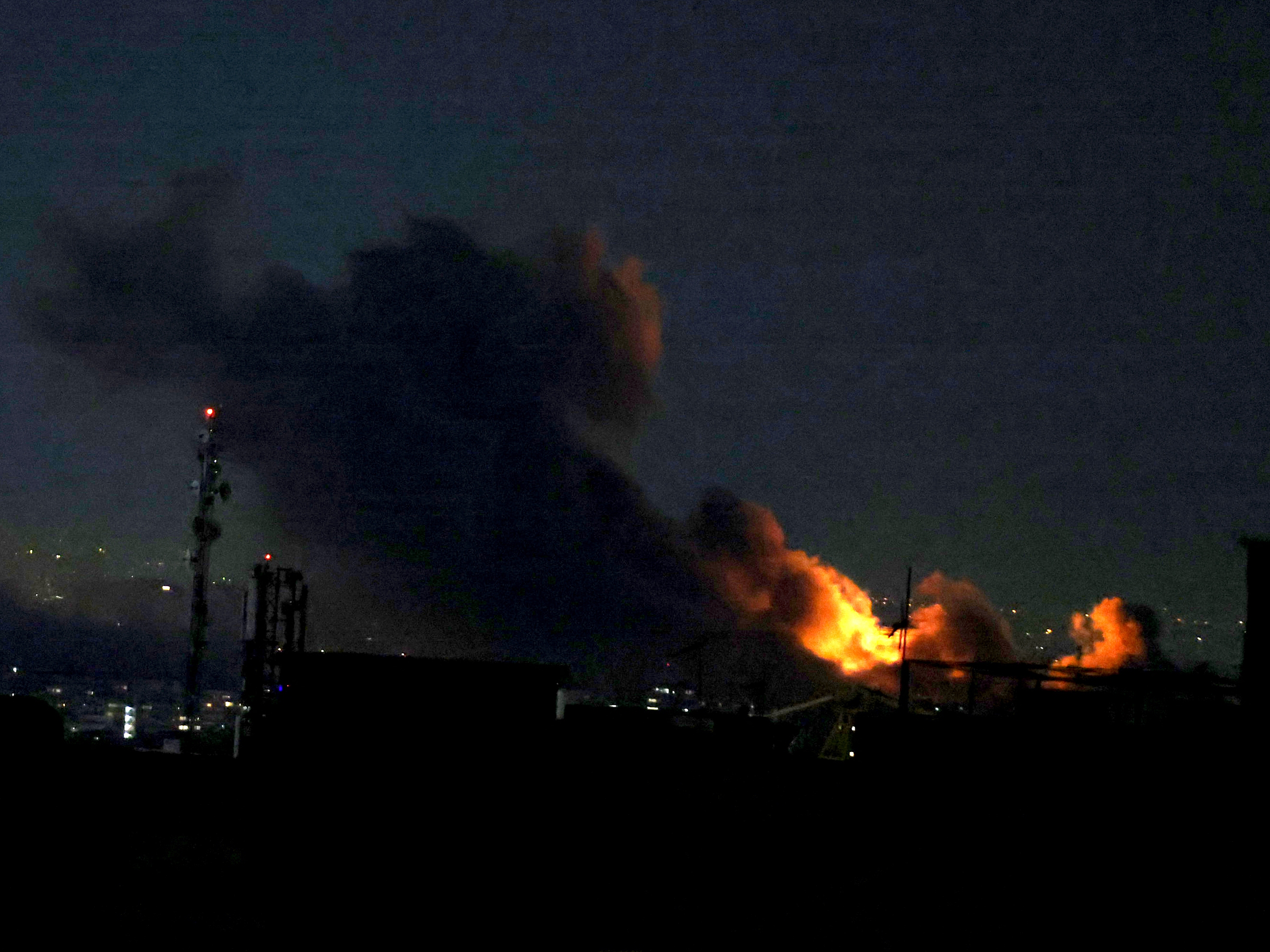 caption: A plume of smoke rises from the site of a strike in Tehran on March 29, 2026.