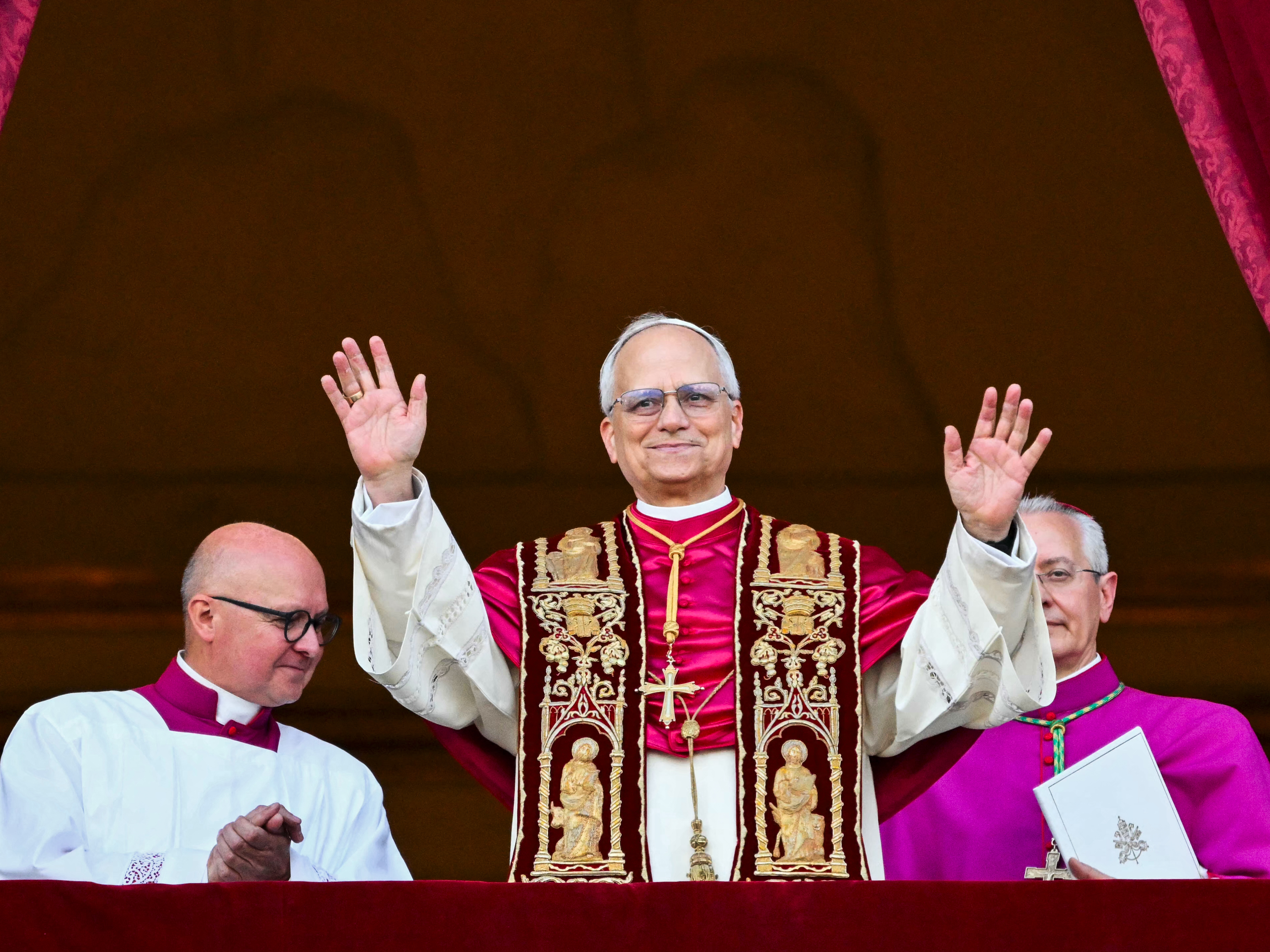 caption: Pope Leo XIV greets followers for the first time after being elected pope.