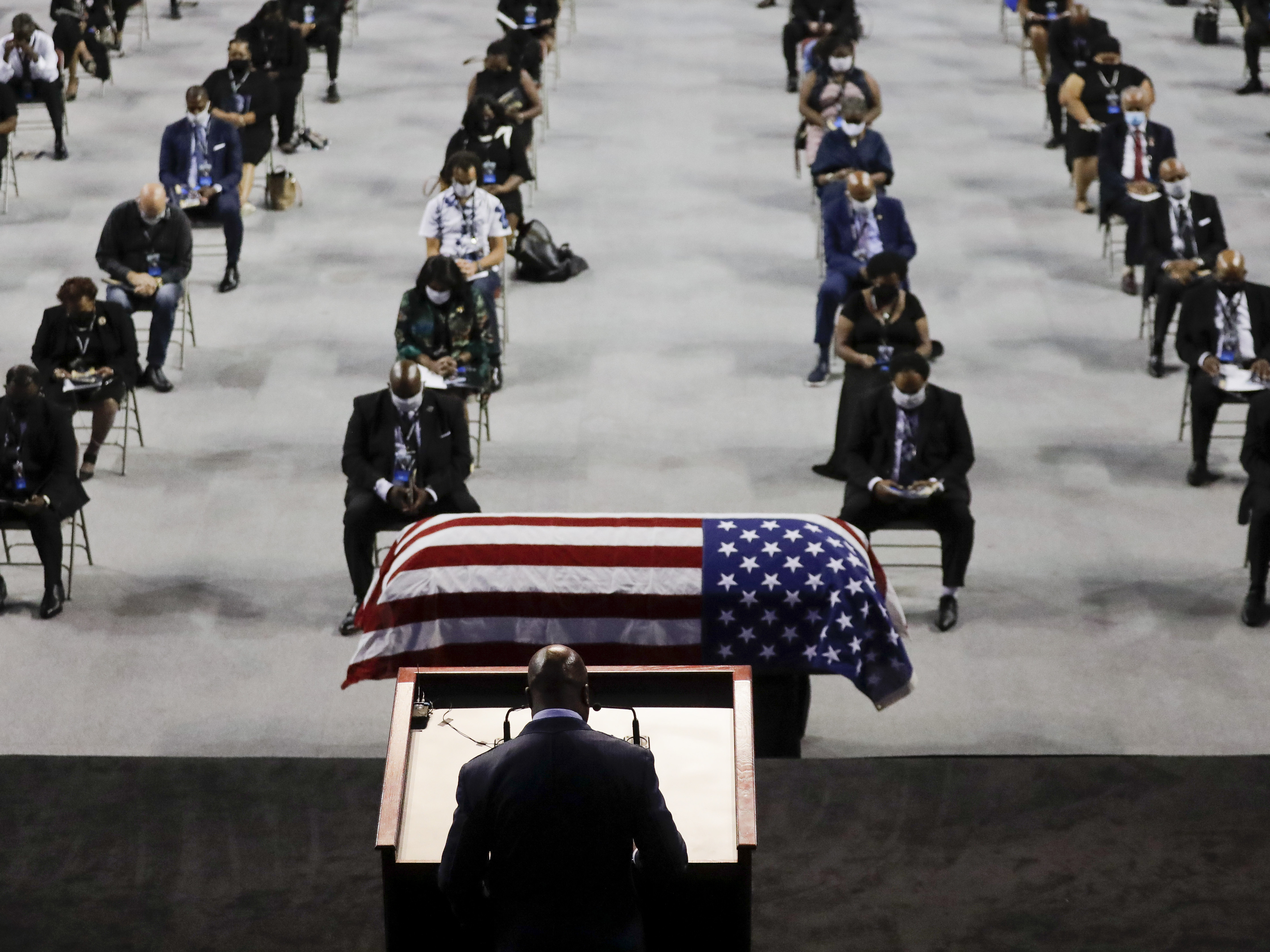caption: The Rev. Darryl Caldwell speaks as the casket of the late Rep. John Lewis, D-Ga., lies in repose during a service at Troy University in Troy, Ala., on Saturday.