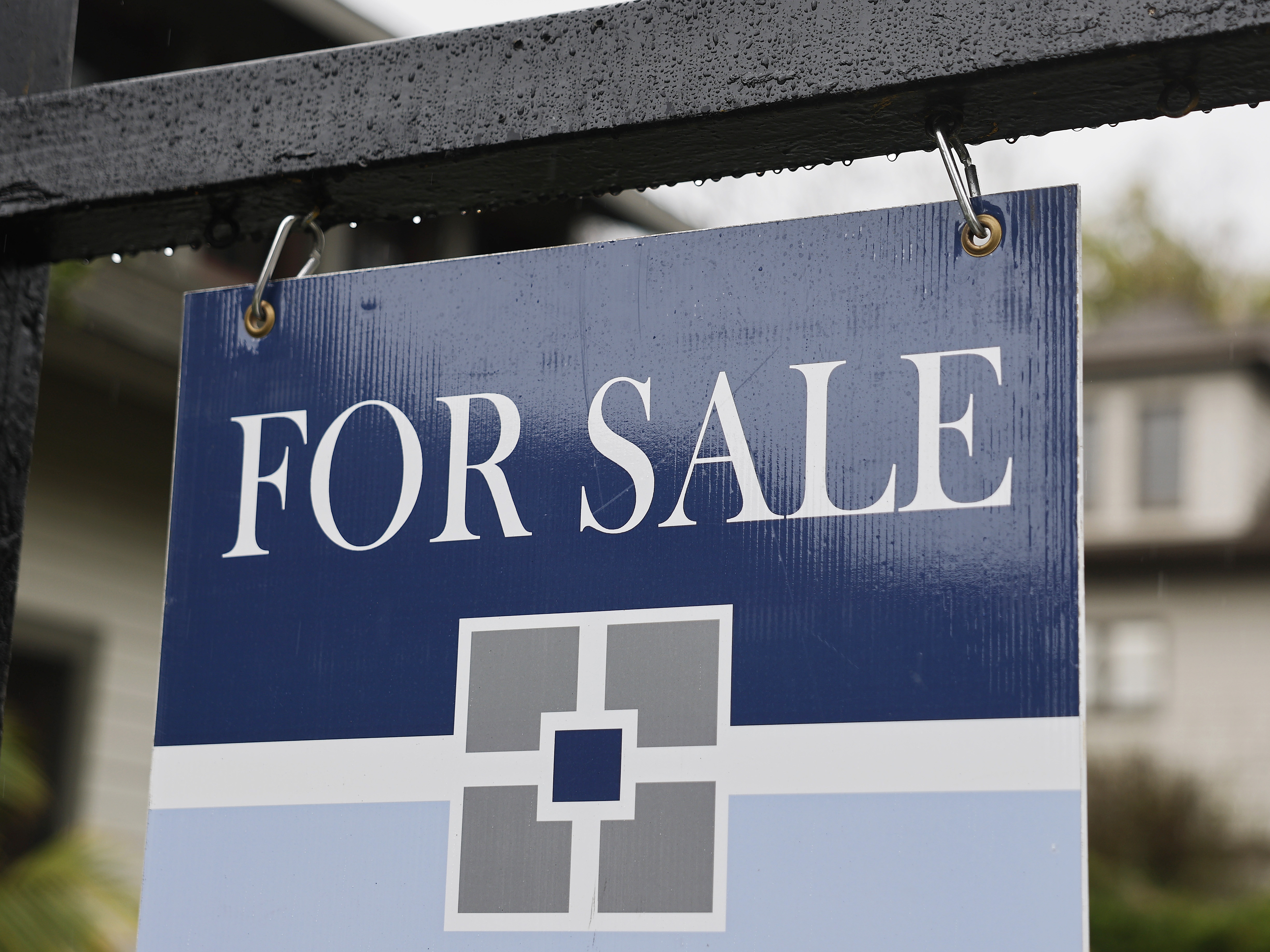 caption: A 'For Sale' sign is posted in front of a home for sale last month in Pasadena, Calif.