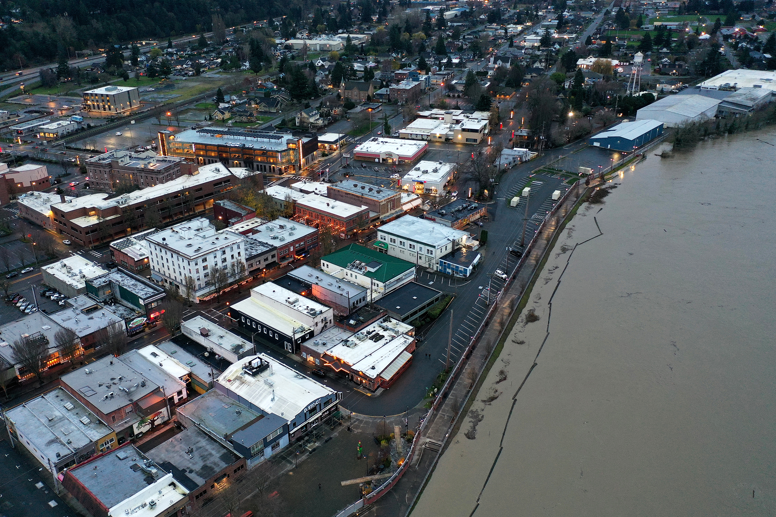 caption: An aerial view of the Skagit River and flood wall is shown early on Thursday, December 11, 2025, in Mount Vernon. 
