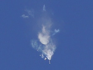 caption: Smoke rises as first-stage boosters separate from a Soyuz rocket with a Soyuz MS-10 spacecraft carrying a NASA astronaut and a Russian cosmonaut. The mission was aborted shortly after launch, and the pair returned to Earth safely in an emergency landing.