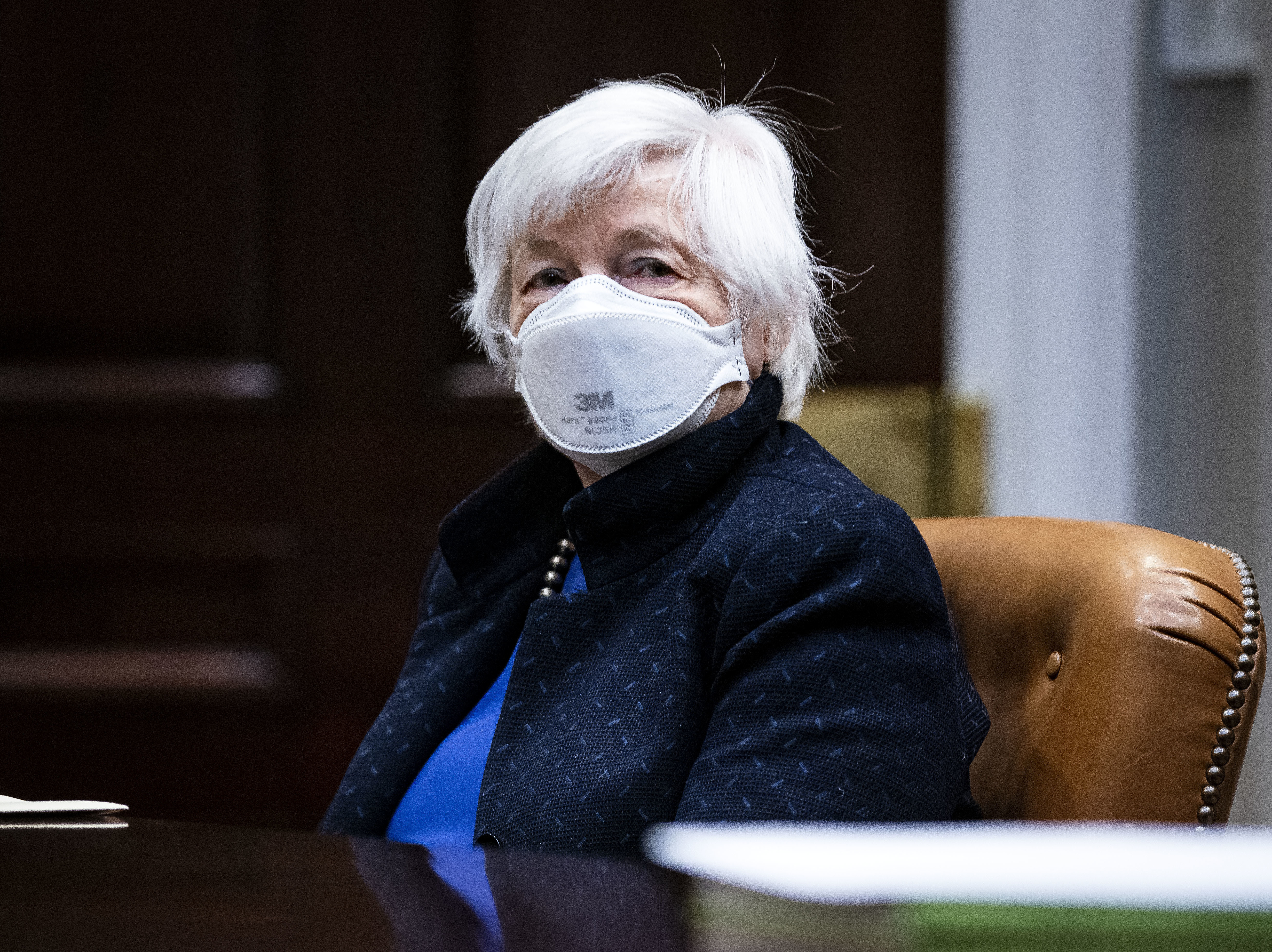 caption: Treasury Secretary Janet Yellen listens during a meeting with President Biden in the White House on March 5. Yellen on Monday proposed a minimum global tax rate for corporations.