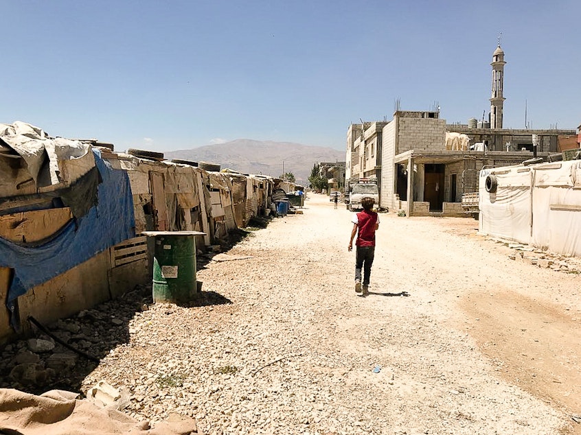caption: An informal tented settlement for Syrian refugees in Lebanon's Bekaa Valley. AHA members filmed at this camp, gathering footage for their fundraising video