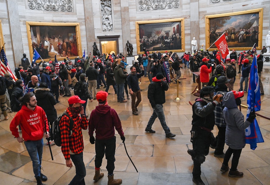 caption: Supporters of President Trump roam the U.S. Capitol Rotunda after storming into the building on Wednesday.