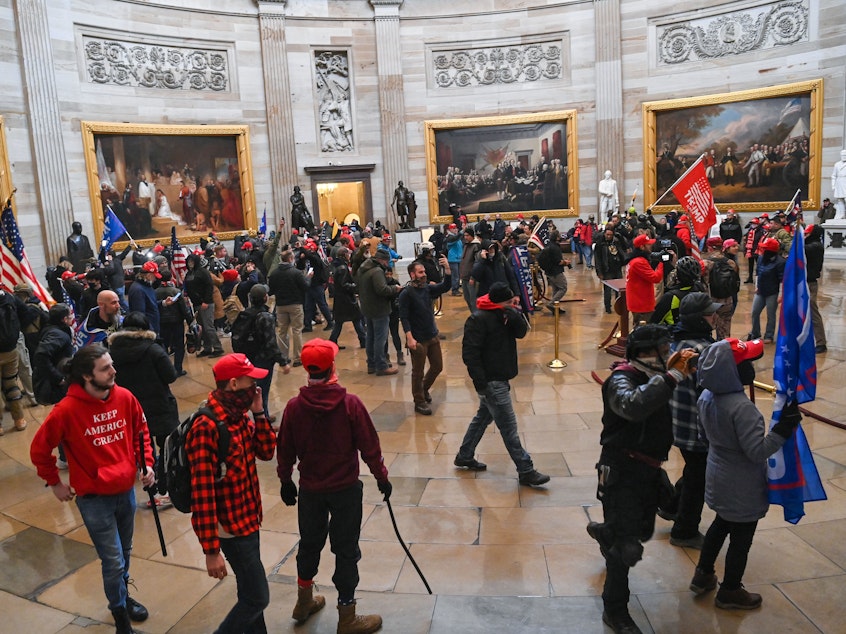 caption: Supporters of President Trump roam the U.S. Capitol Rotunda after storming into the building on Wednesday.