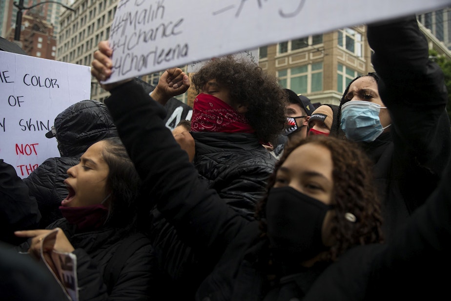 caption: Protesters chant toward Seattle Police officers on Saturday, May 30, 2020, in Seattle. Thousands gathered in a protest that turned violent following the police killing of George Floyd, a black man who was killed by a white police officer who held his knee on Floyd's neck for 8 minutes and 46 seconds, as he repeatedly said, 'I can't breathe,' in Minneapolis on Memorial Day. 