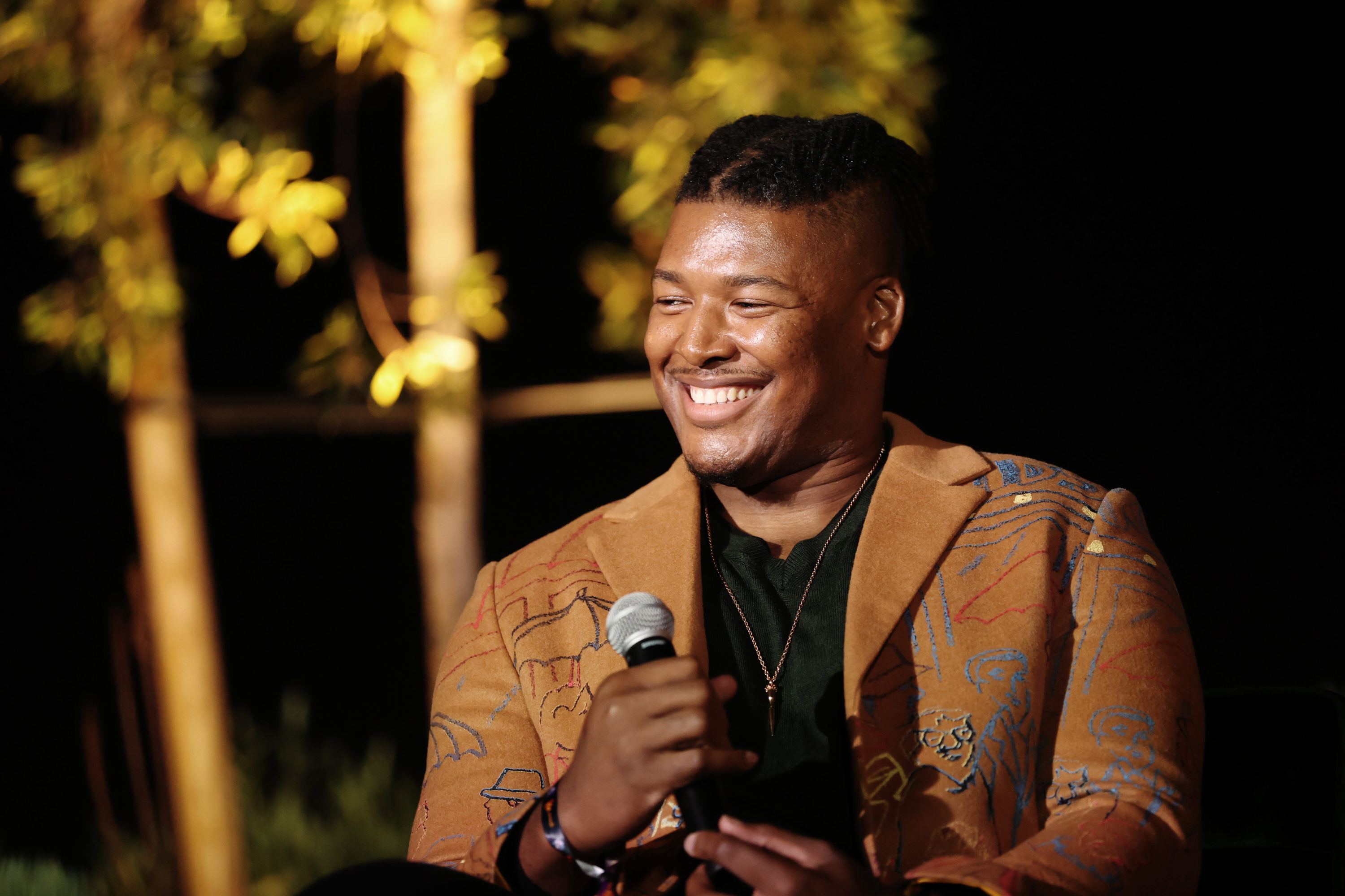 caption: R.K. Russell speaks onstage during A Night of Pride with GLAAD and NFL on February 10, 2022 in Los Angeles, California. (Rich Polk/Getty Images for GLAAD)
