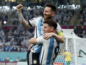 caption: Argentina's Julián Álvarez celebrates while holding Lionel Messi after scoring the team's second goal during the 2022 World Cup's Round of 16 match with Australia at the Ahmad Bin Ali Stadium on Saturday, Dec. 3, in Doha, Qatar.