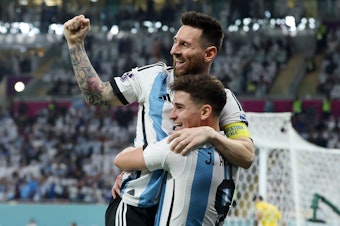 caption: Argentina's Julián Álvarez celebrates while holding Lionel Messi after scoring the team's second goal during the 2022 World Cup's Round of 16 match with Australia at the Ahmad Bin Ali Stadium on Saturday, Dec. 3, in Doha, Qatar.
