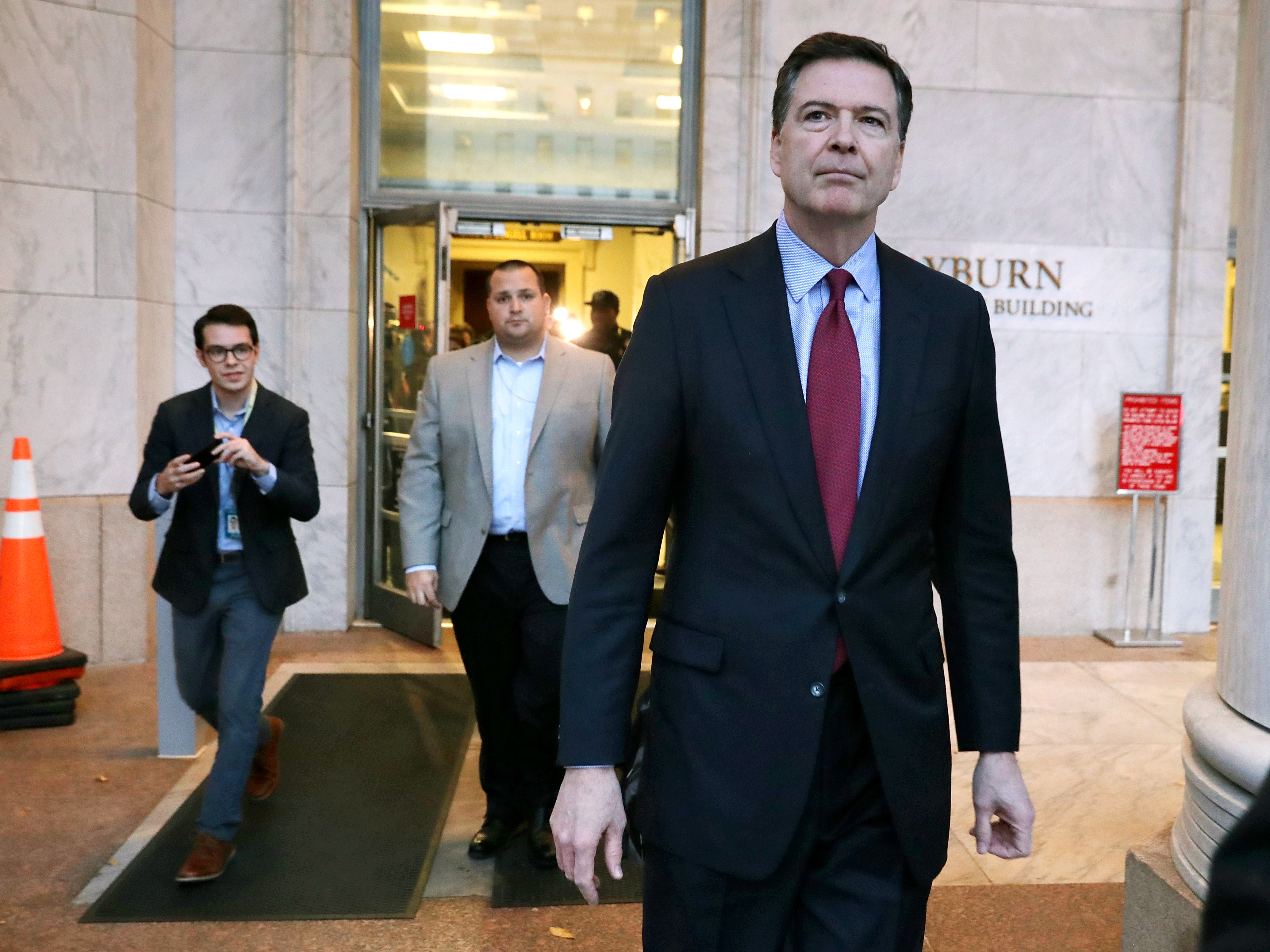 caption: Former Federal Bureau of Investigation Director James Comey leaves the Rayburn House Office Building after testifying to two House committees on Dec. 7, 2018, in Washington, D.C.