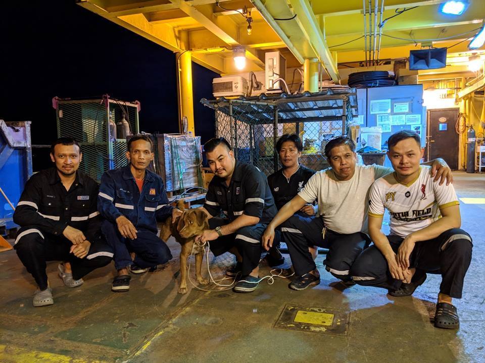 caption: Boonrod poses with oil rig workers in the Gulf of Thailand.