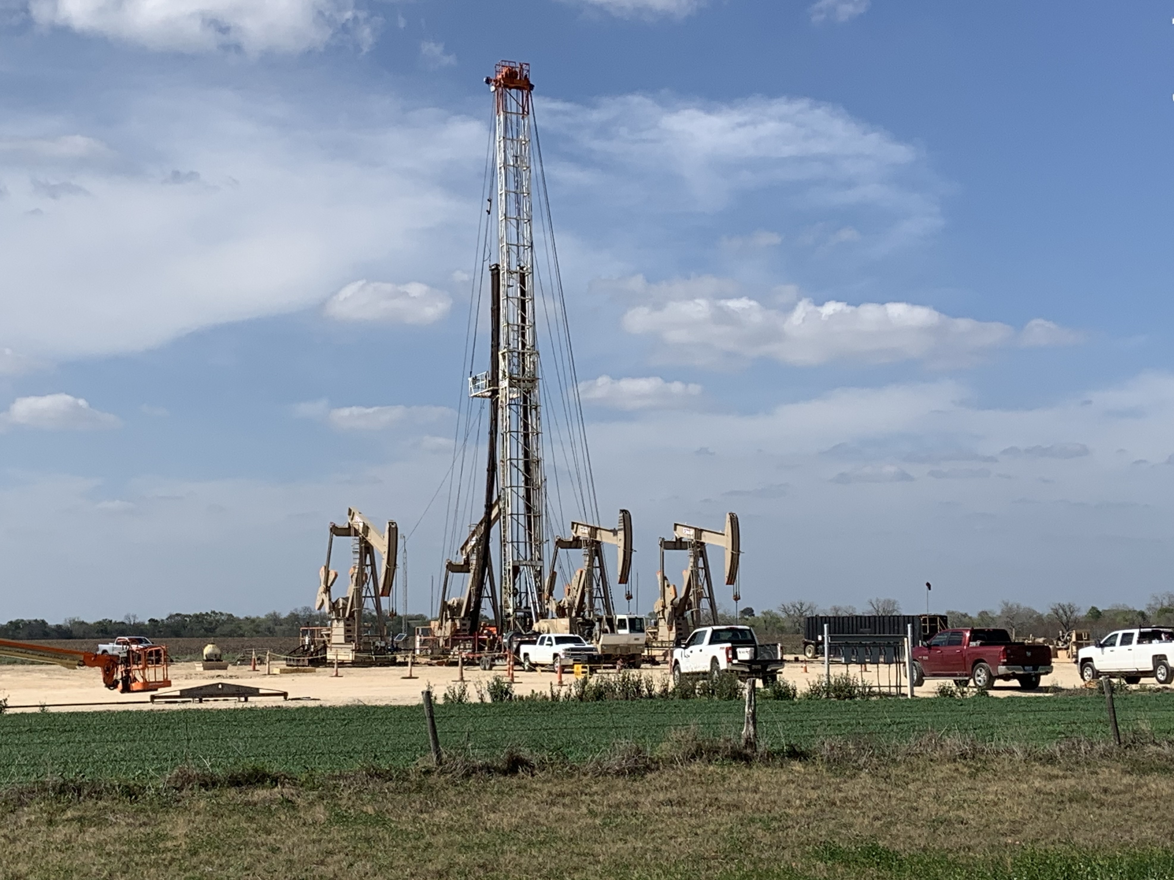 caption: An oil drilling rig near Karnes City, Texas, continued work as oil prices collapsed this week. Companies already were cutting costs and now will have to cut deeper as oil prices remain low.