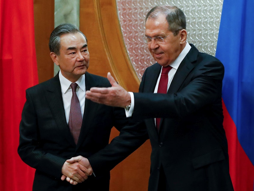 caption: China's foreign minister, Wang Yi, stressed to his Russian counterpart, Sergey Lavrov, that China wanted "dialogue and negotiation," rather than military means, to solve tensions.
