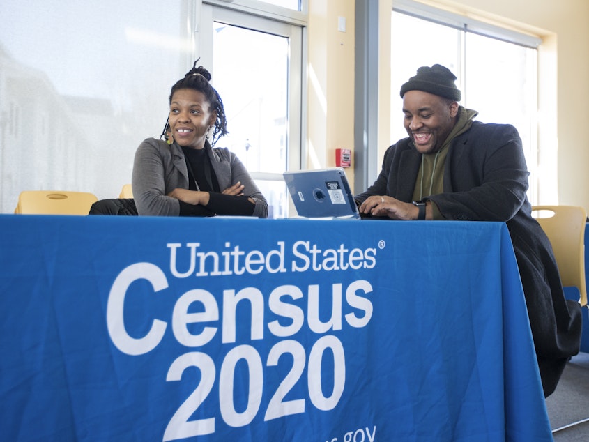 caption: Chris Worrell jokes with Teresa Jefferson while applying for a 2020 census job in Boston in February before the COVID-19 pandemic. Based on government records, the Census Bureau estimates the U.S. population has grown by as much as 8.7% since 2010.