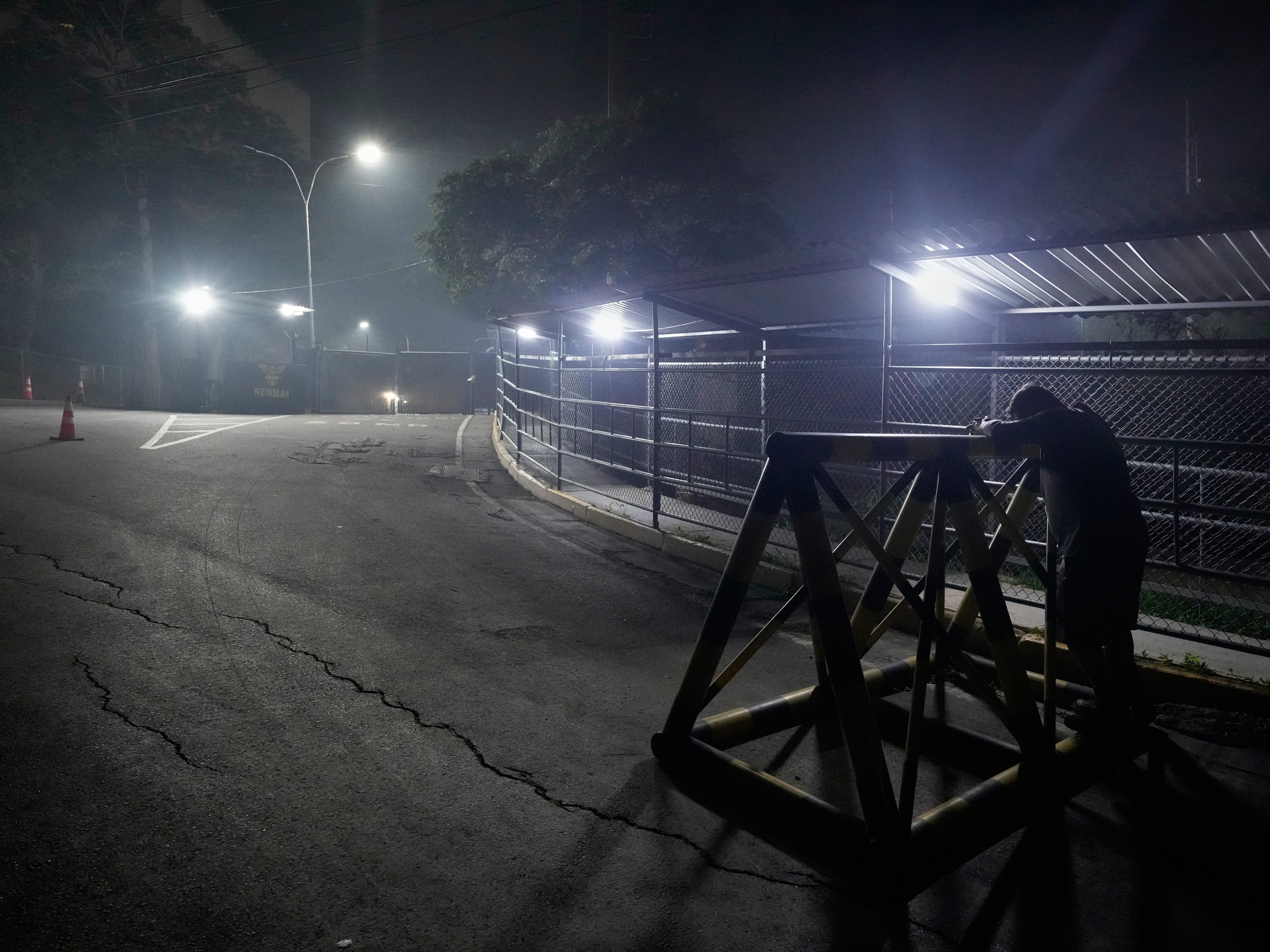caption: A relative of a political prisoner waits outside the Rodeo I prison in Guatire, Venezuela, Thursday, Jan. 8, 2026, after National Assembly President Jorge Rodriguez said the government would release Venezuelan and foreign prisoners.