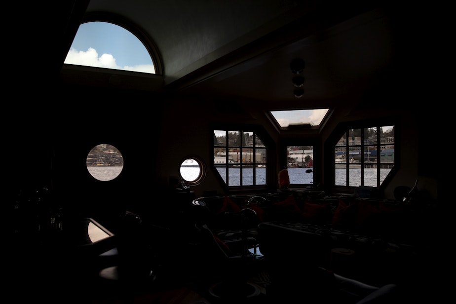 caption: The interior of Janet Yoder and Robert Rudine’s houseboat, the self declared sovereign nation of Tui Tui, is shown on Tuesday, March 26, 2024, in Seattle. 