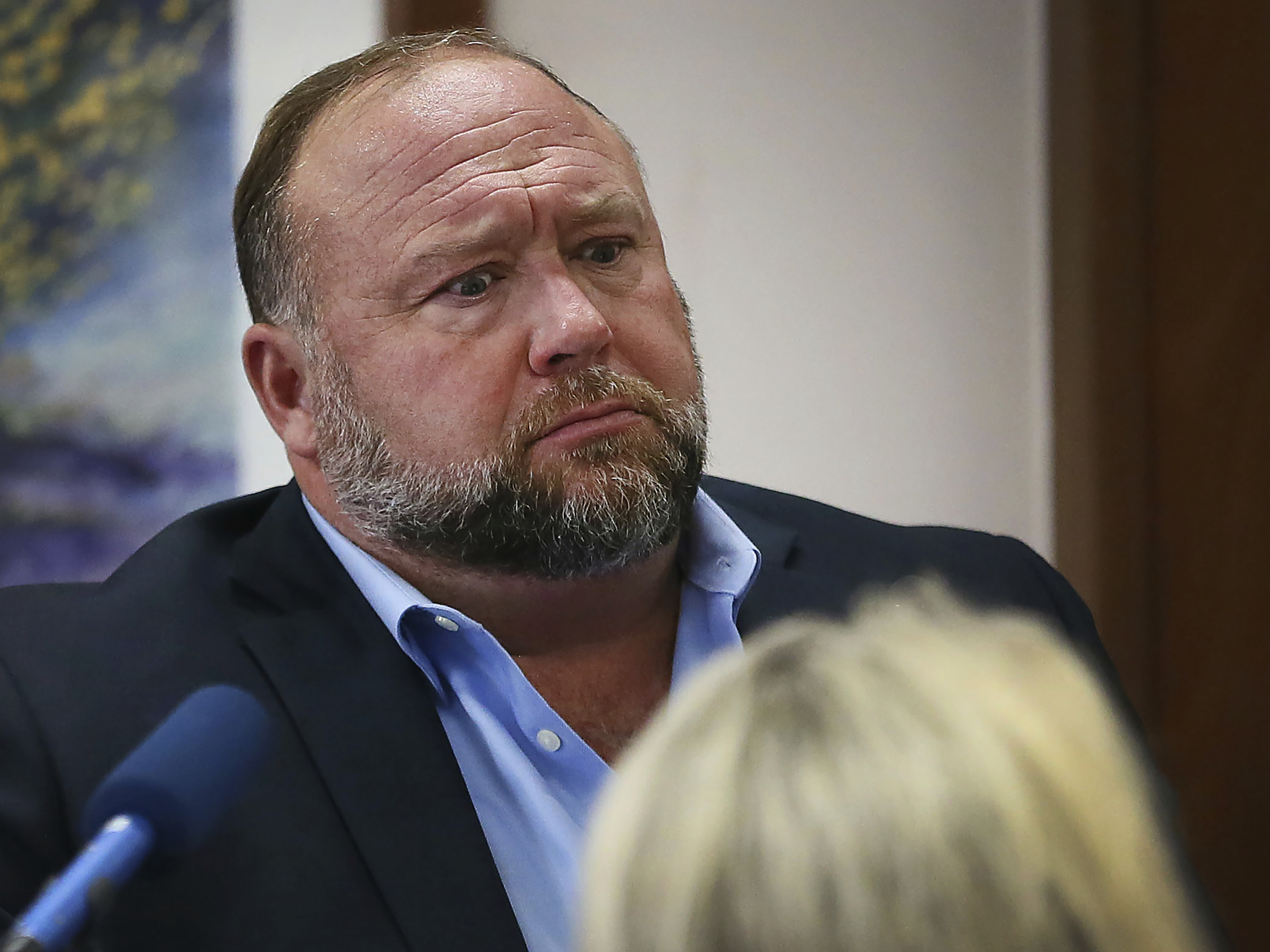 caption: InfoWars host and conspiracy theorist Alex Jones has been ordered to pay just under $50 million in damages to a pair of parents whose son was killed in the 2012 mass shooting at Sandy Hook Elementary.