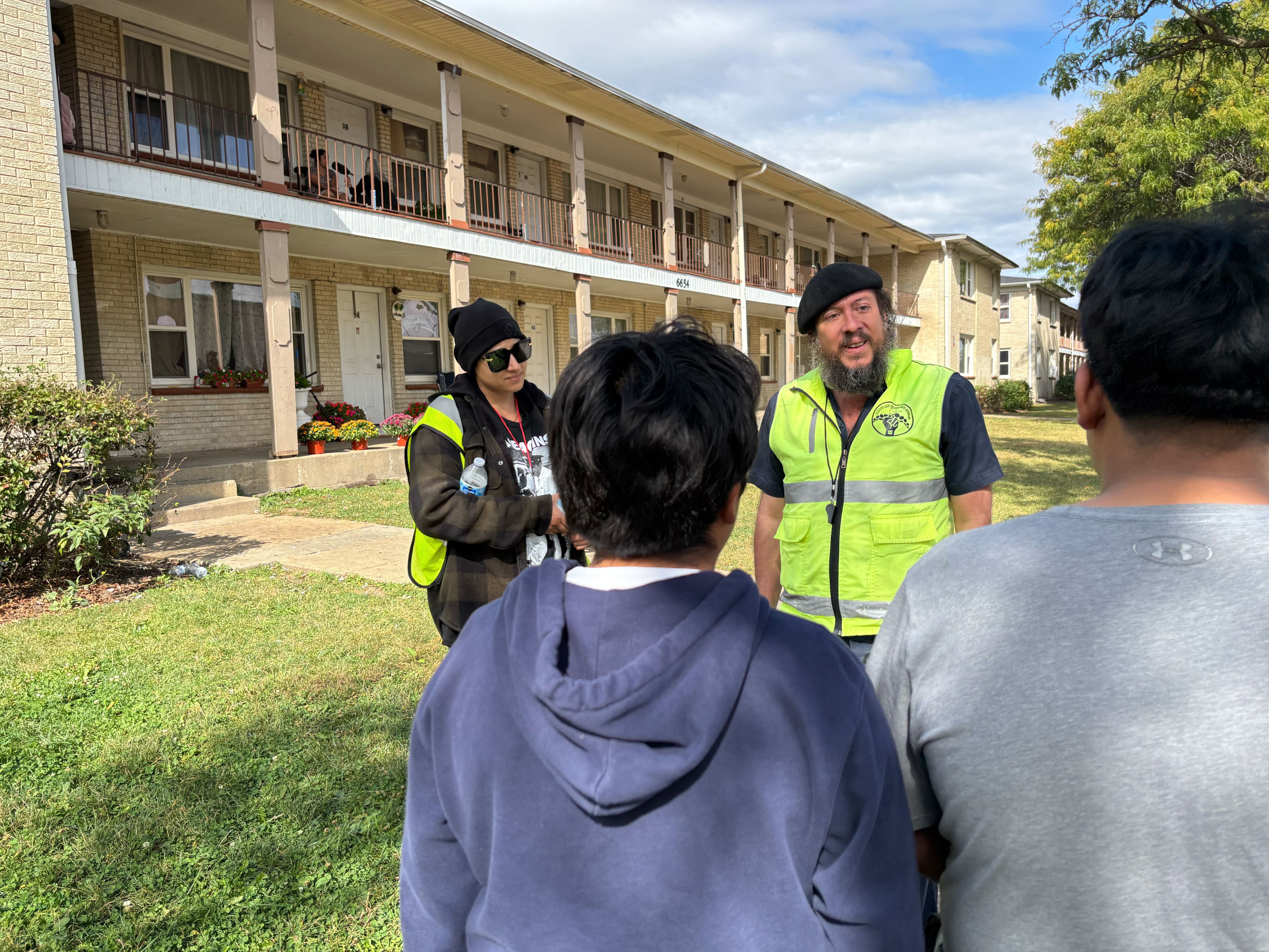 caption: Organizers with the People's Patrol  talk to immigrant kids in Hanover Park, a suburb of Chicago, on October 10, 2025.