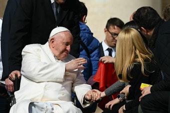 caption: Pope Francis blesses a guest on March 29, 2023 during the weekly general audience at St. Peter's square in The Vatican.