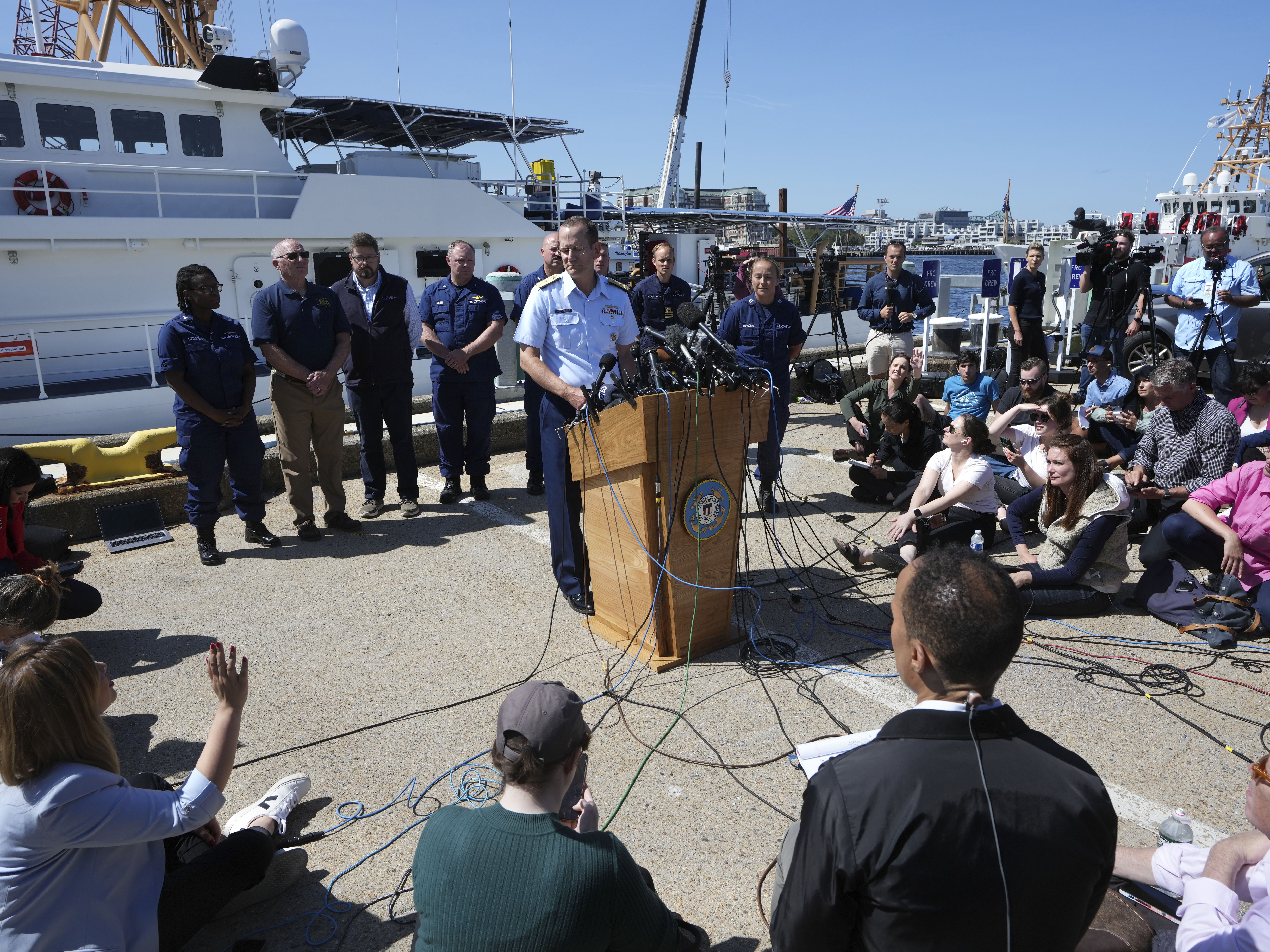 caption: U.S. Coast Guard Rear Adm. John Mauger, commander of the First Coast Guard District talks to the media on June 22, 2023, at Coast Guard Station Boston.