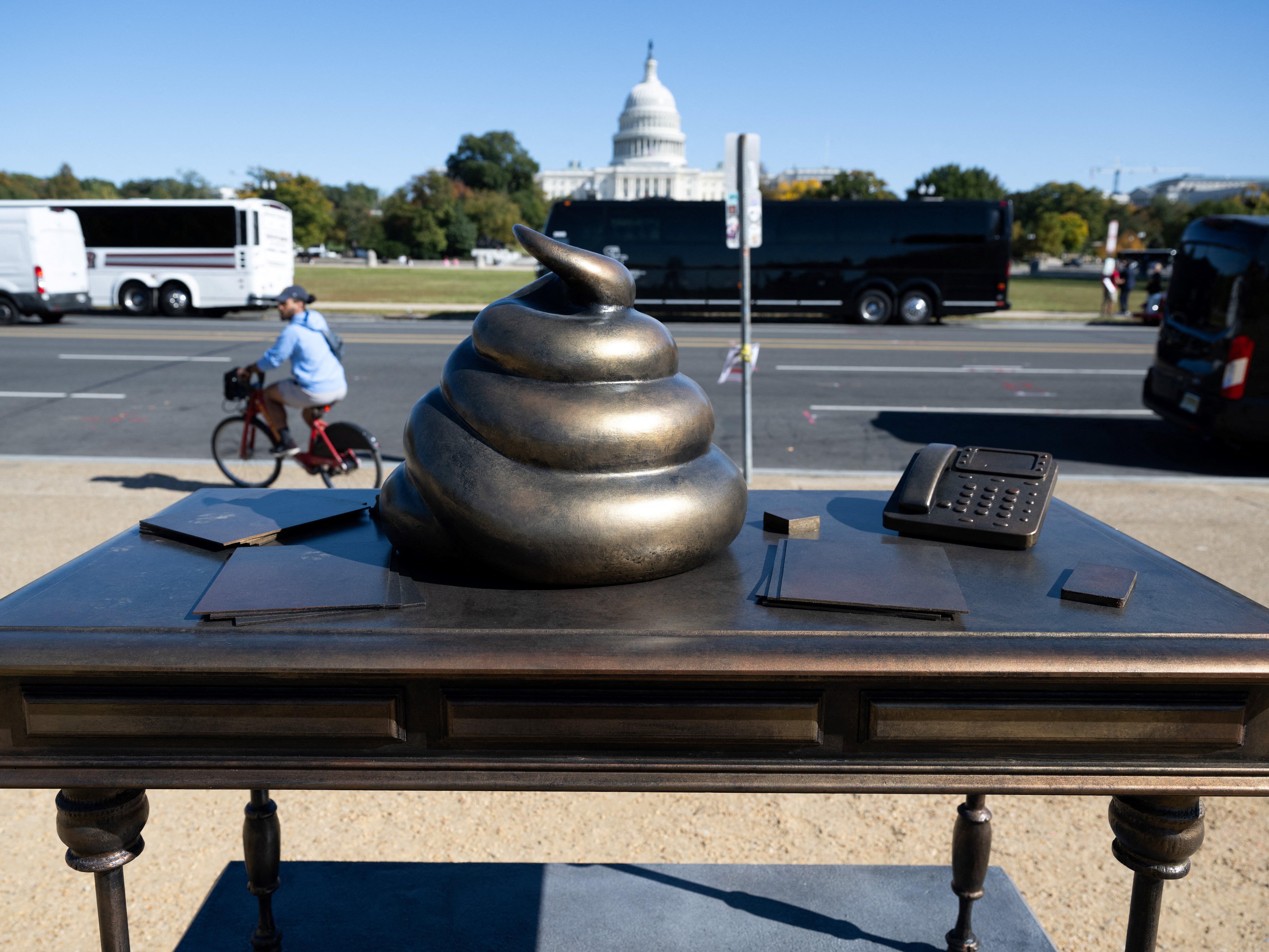 caption: A bronze art installation depicting a pile of feces on former House Speaker Nancy Pelosi's desk appeared on the National Mall near the U.S. Capitol on Thursday, surprising and amusing passersby.
