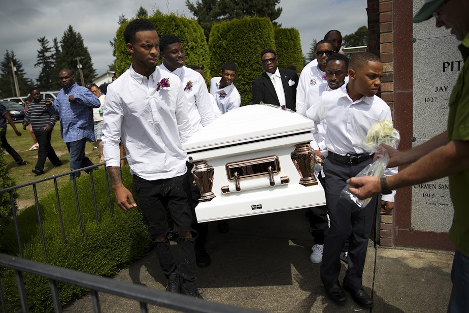 caption: Pall bearers carry the casket of Charleena Lyles during a burial ceremony at Hillcrest Burial Park on Monday, July 10, 2017, in Kent, Washington. 