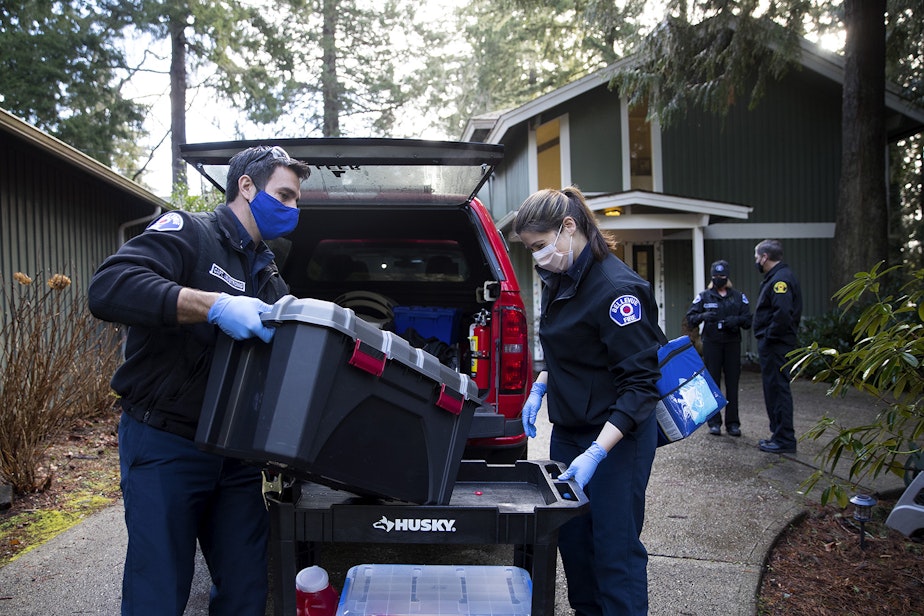caption: Bellevue firefighters Ryan Armstrong, left, and Alexa Dillhoff, right load supplies into a vehicle after vaccinating residents of the Optimus Family Home against Covid-19 on Friday, February 5, 2021, in Bellevue. 