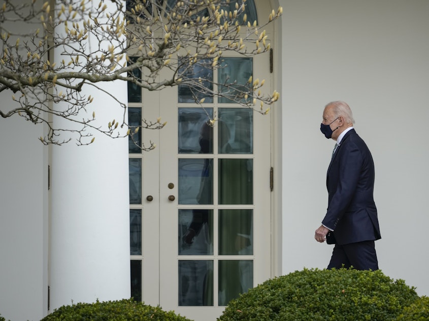 caption: President Biden walks to the Oval Office on Wednesday.
