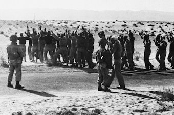 caption: Israeli troops round up Egyptian soldiers captured during fighting in 1956 in the Rafah area of the Gaza Strip, which was controlled by Egypt at the time. Israel, Britain and France invaded Egyptian territory after Egypt moved to nationalize the Suez Canal. But U.S. President Dwight Eisenhower intervened, leading to the withdrawal of foreign troops, including the Israeli forces in Gaza.