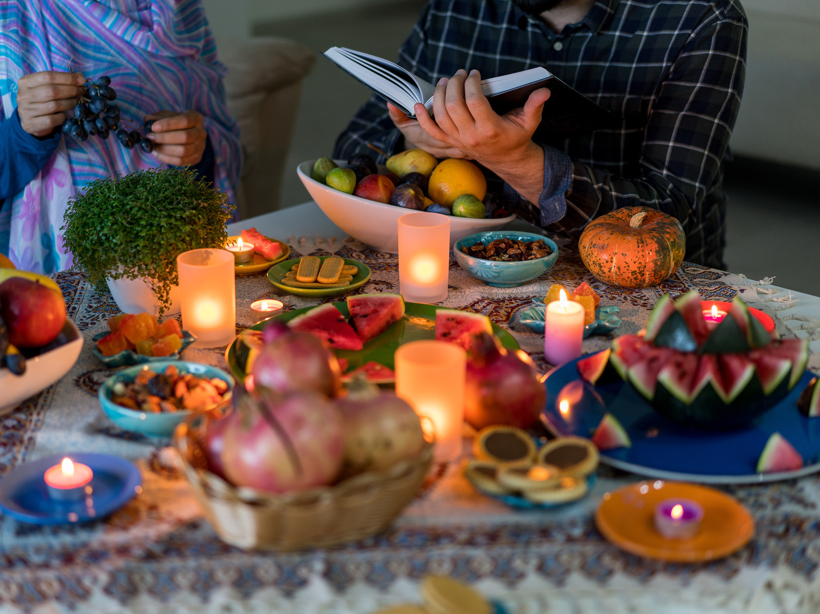 caption: On Yalda night, the Iranian winter solstice tradition, observers gather with family and read classic poetry aloud to greet the returning sun.